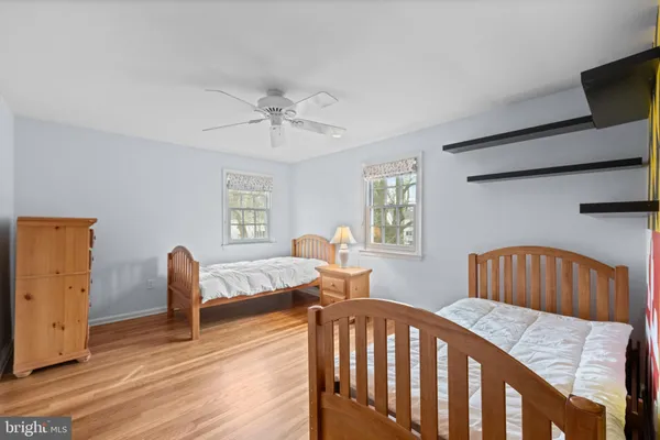 a bedroom with furniture and wooden floor