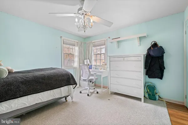 a spacious bedroom with a bed and a chandelier