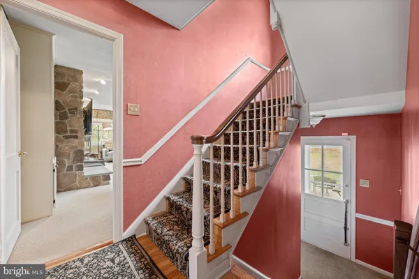 a view of entryway and hall with wooden floor