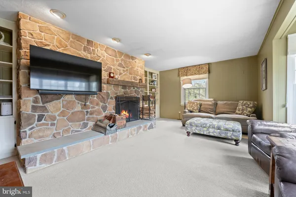 a living room with furniture flat screen tv and a fireplace