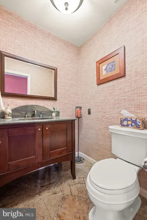 a bathroom with a toilet a sink and mirror
