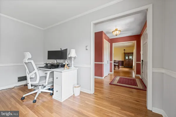a view of a workspace with wooden floor and a bathroom