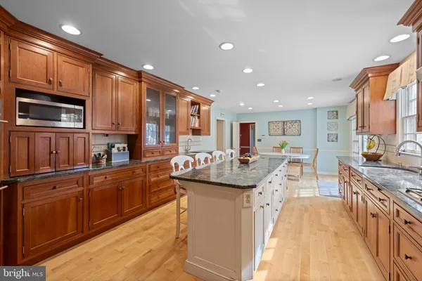 a kitchen with counter top space a sink appliances and cabinets