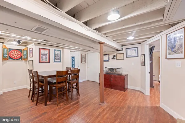 a view of a dining room with furniture and wooden floor