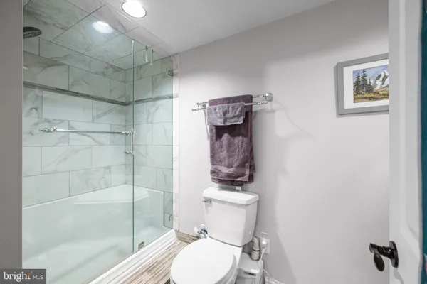 a bathroom with a toilet and a shower