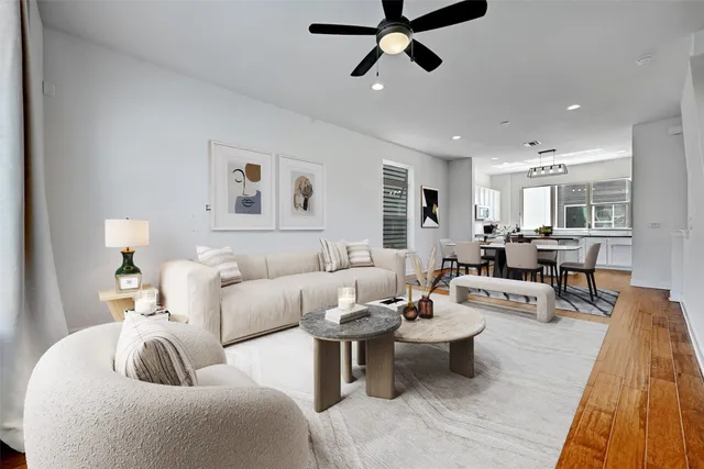 a living room with furniture and a wooden floor