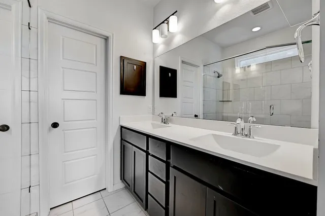 a bathroom with a double vanity sink a and mirror