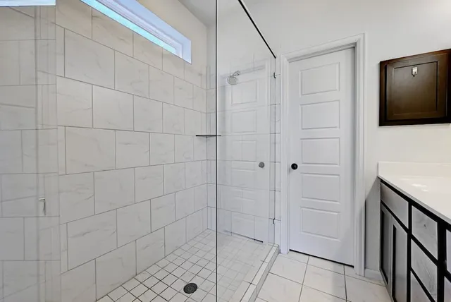 a bathroom with a shower and a mirror