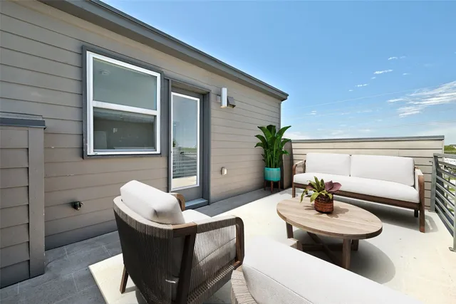 a view of a patio with couches and potted plants
