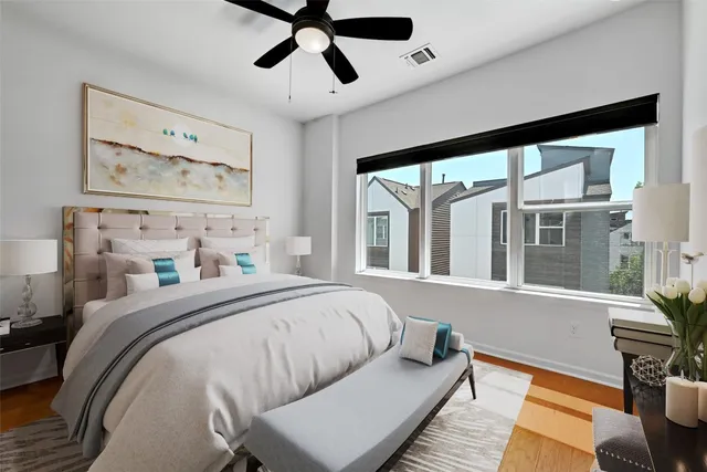 a bedroom with a bed and wooden floor