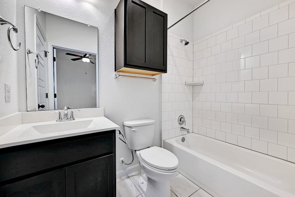 1412 Waterloo Shore Lane Austin, TX 78741 - Photo 22 of 30 a bathroom with a sink a toilet and shower