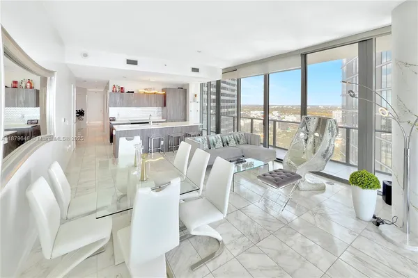a living room with a large window and furniture