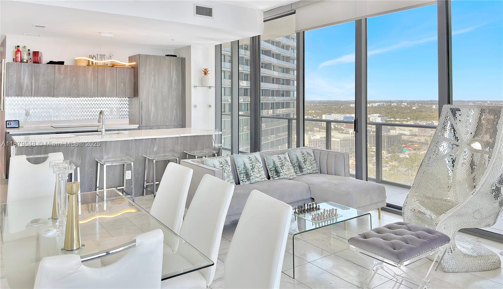 480 Northeast 31st Street, Unit 2407 Miami, FL 33137 - Photo 13 of 35 a living room with furniture and a floor to ceiling window