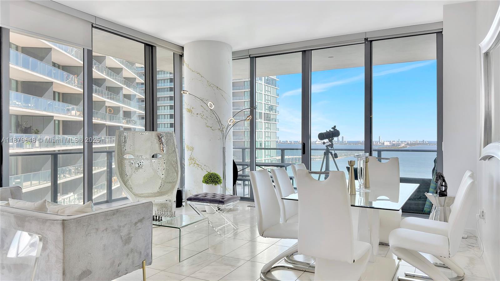 480 Northeast 31st Street, Unit 2407 Miami, FL 33137 - Photo 14 of 35 a living room with furniture and floor to ceiling windows
