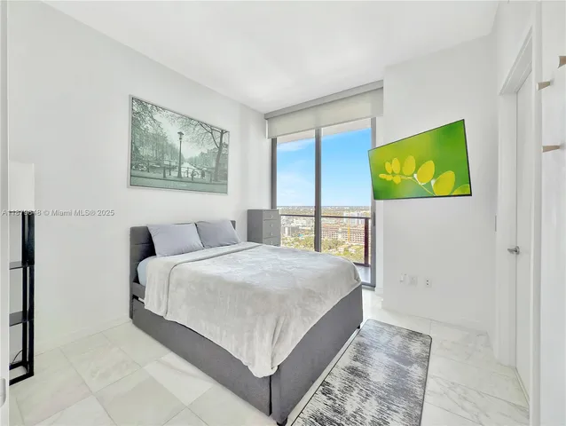 a bedroom with a bed and a painting on the wall