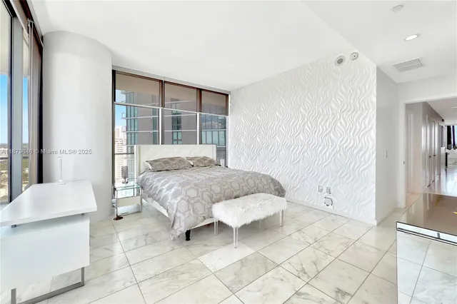 a bedroom with a bed and a mirror