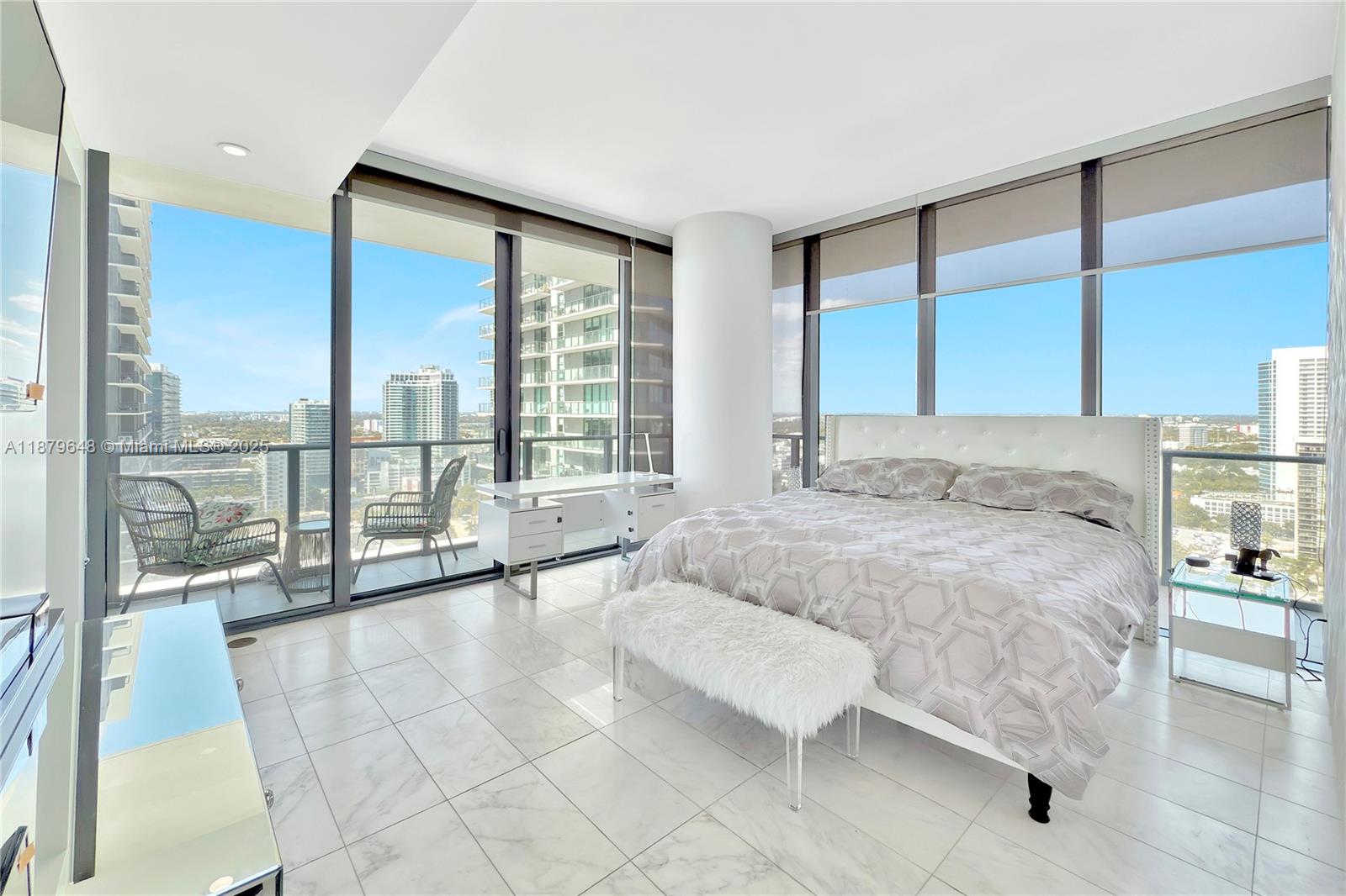 480 Northeast 31st Street, Unit 2407 Miami, FL 33137 - Photo 27 of 35 a spacious bedroom with a large window and a bed