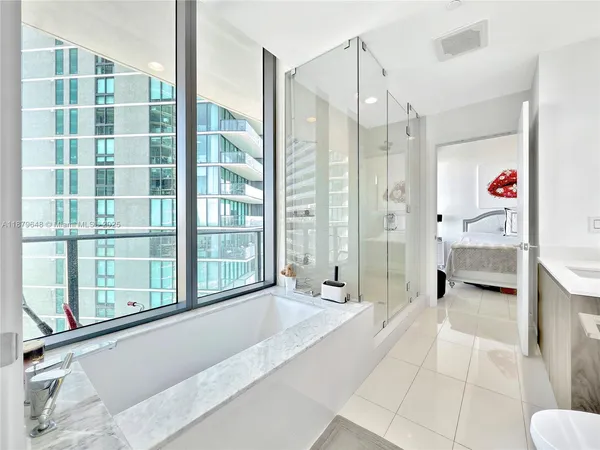 a spacious bathroom with a tub shower and sink