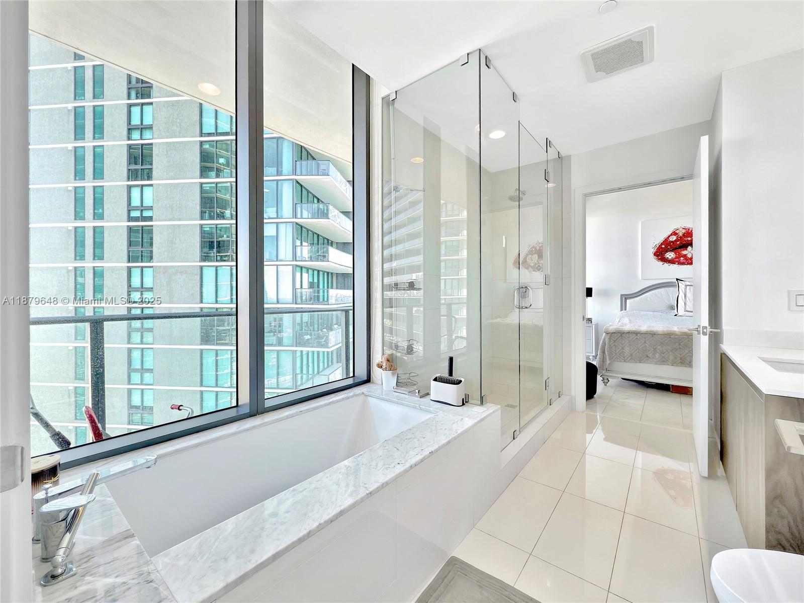 480 Northeast 31st Street, Unit 2407 Miami, FL 33137 - Photo 33 of 35 a spacious bathroom with a tub shower and sink