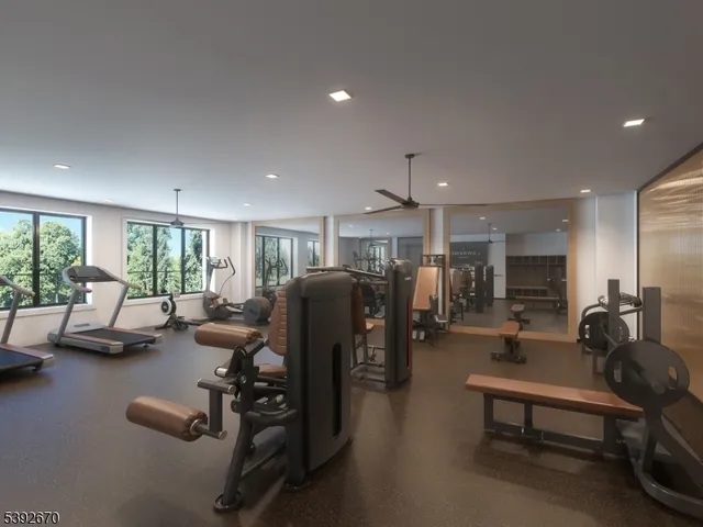 a living room with furniture gym equipment and a large window