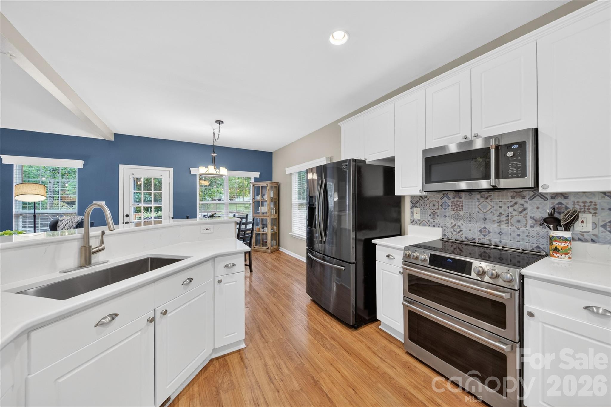 10502 Hellebore Road Charlotte, NC 28213 - Photo 11 of 48 a kitchen with granite countertop a refrigerator and a stove top oven
