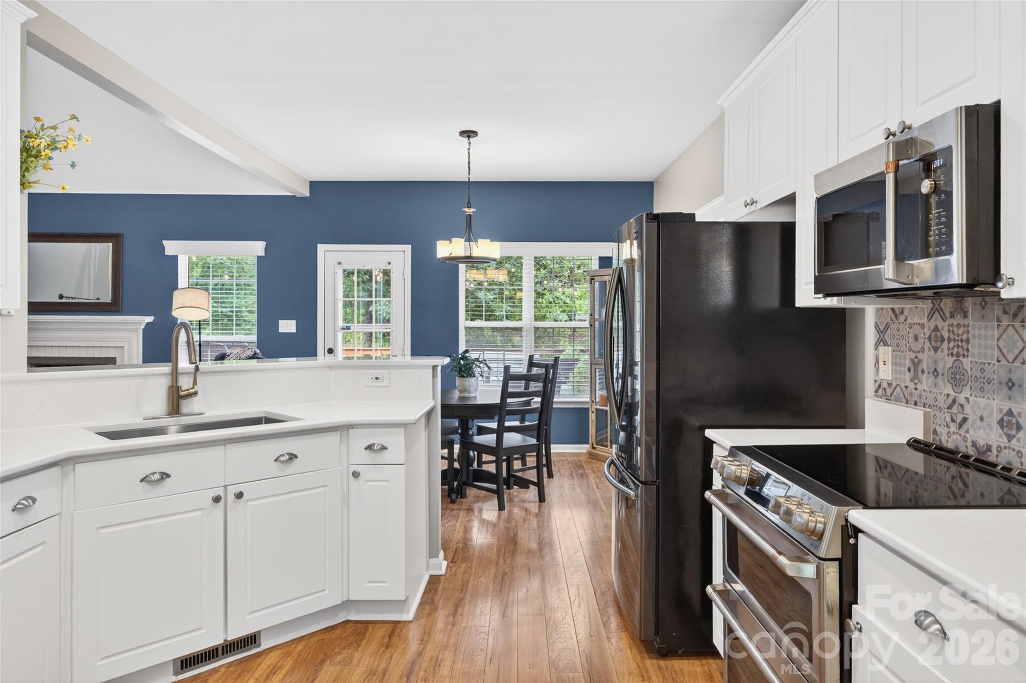 10502 Hellebore Road Charlotte, NC 28213 - Photo 12 of 48 a kitchen with a sink a microwave a stove and refrigerator