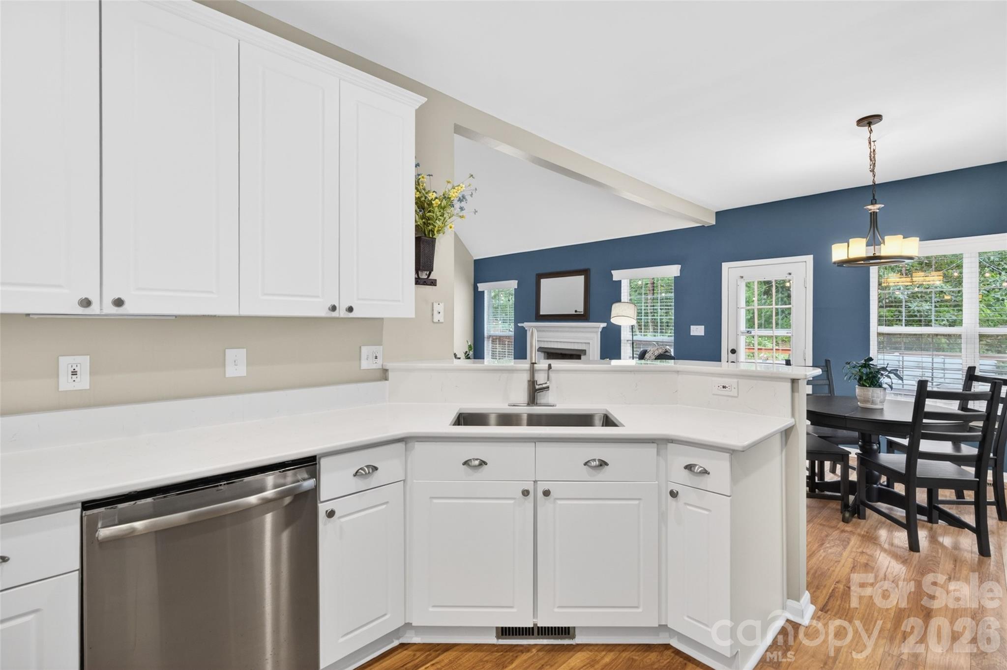 10502 Hellebore Road Charlotte, NC 28213 - Photo 13 of 48 a kitchen with kitchen island granite countertop a sink cabinets and wooden floor