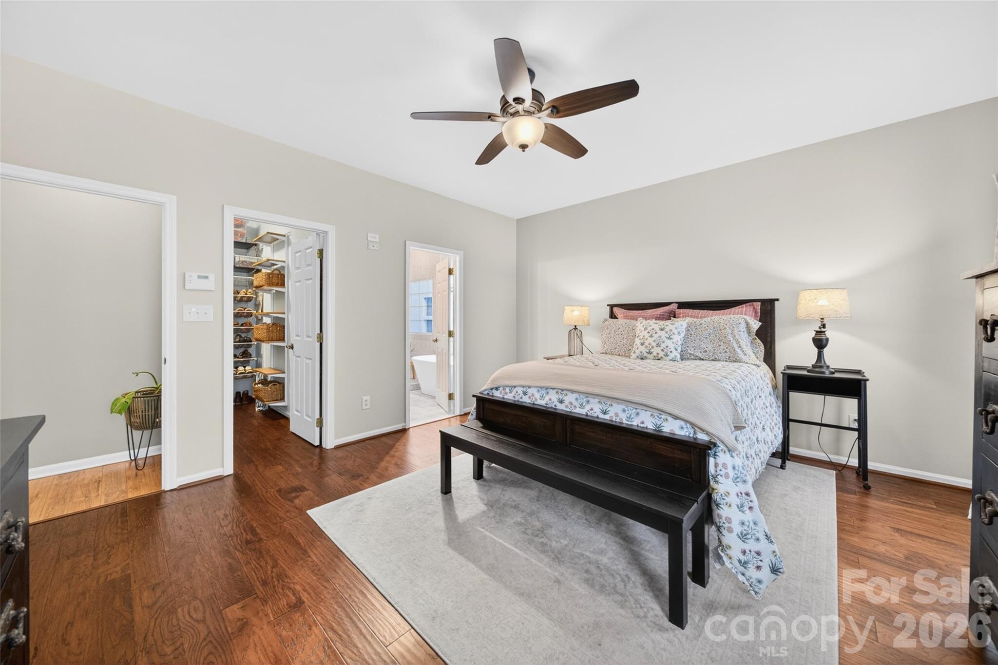 10502 Hellebore Road Charlotte, NC 28213 - Photo 17 of 48 a bedroom with a bed and wooden floor