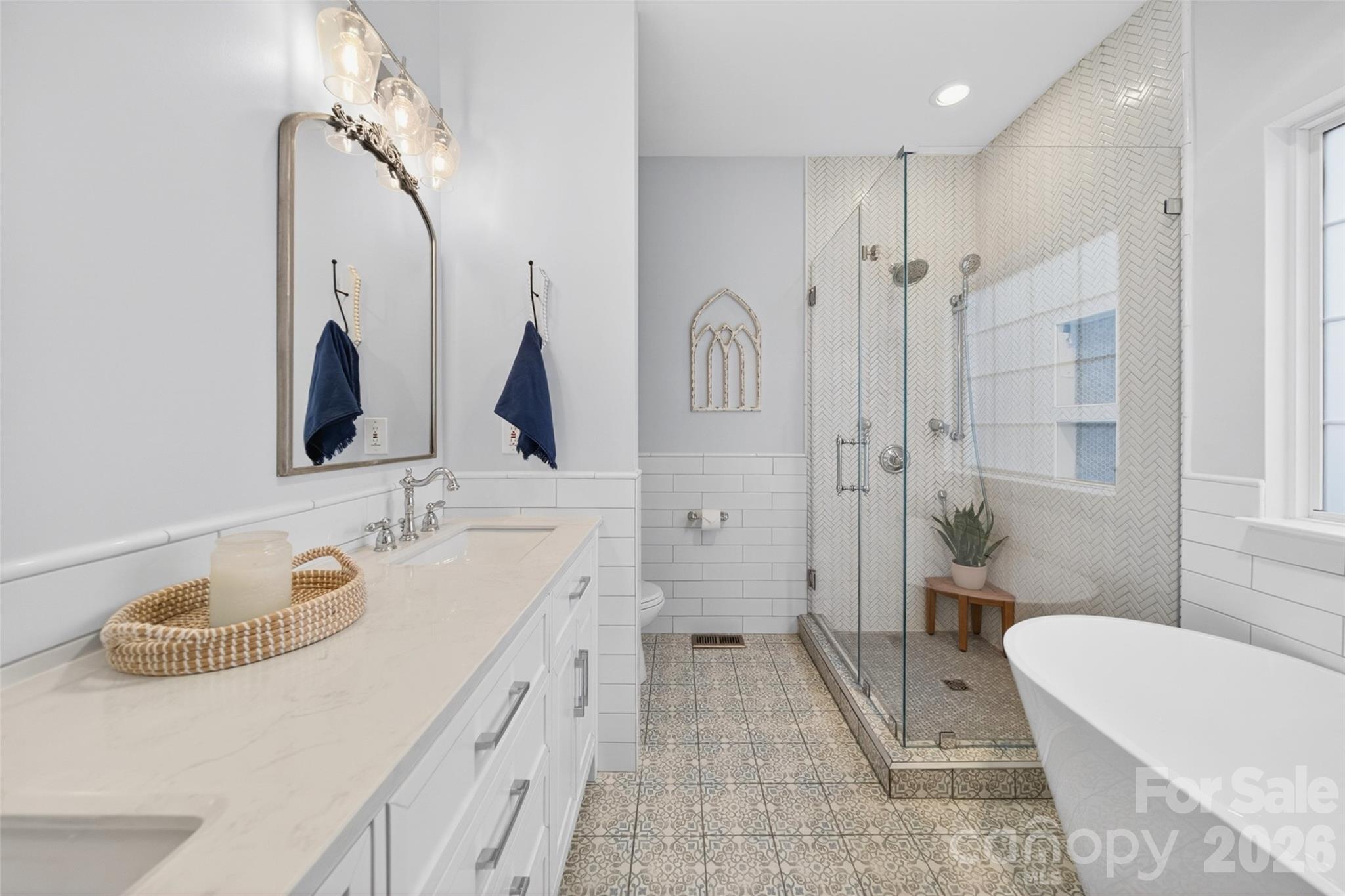 10502 Hellebore Road Charlotte, NC 28213 - Photo 20 of 48 a spacious bathroom with a tub sink mirror and toilet