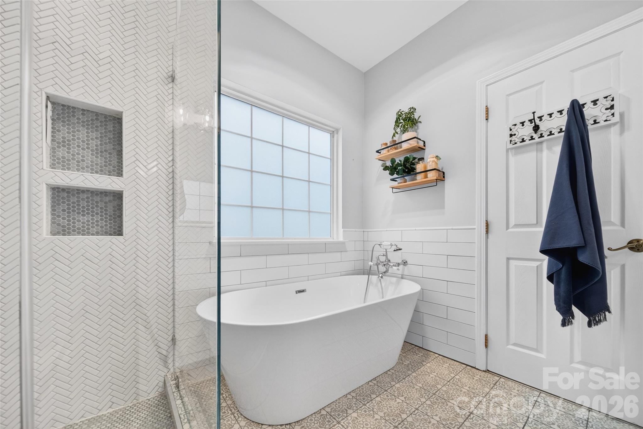 10502 Hellebore Road Charlotte, NC 28213 - Photo 21 of 48 a bathroom with a bathtub and shower