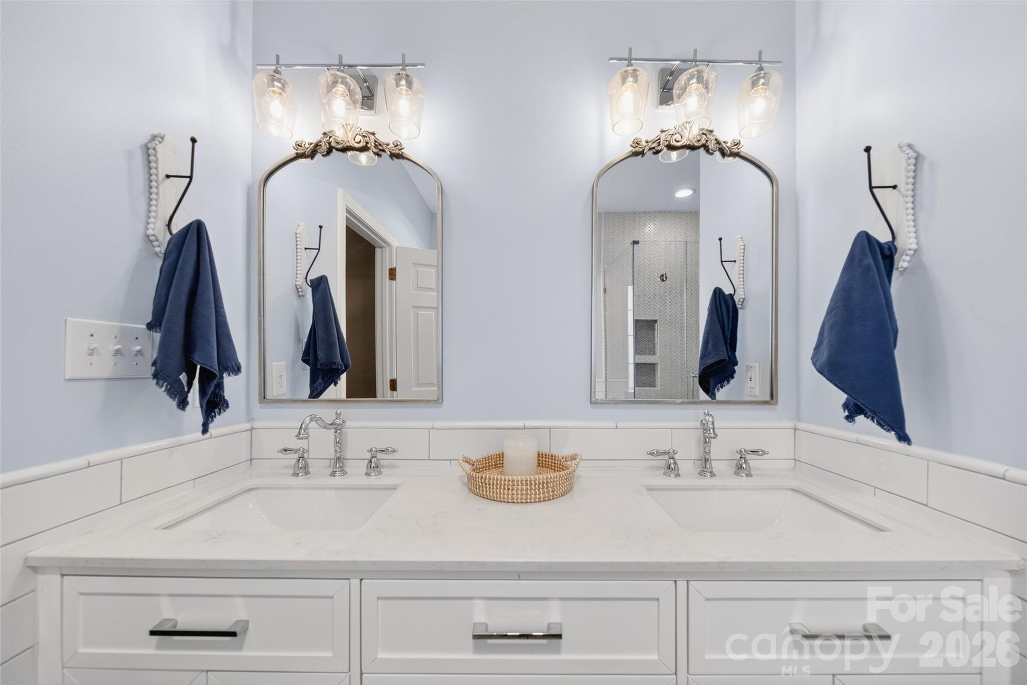 10502 Hellebore Road Charlotte, NC 28213 - Photo 22 of 48 a bathroom with double vanity sinks and a mirror