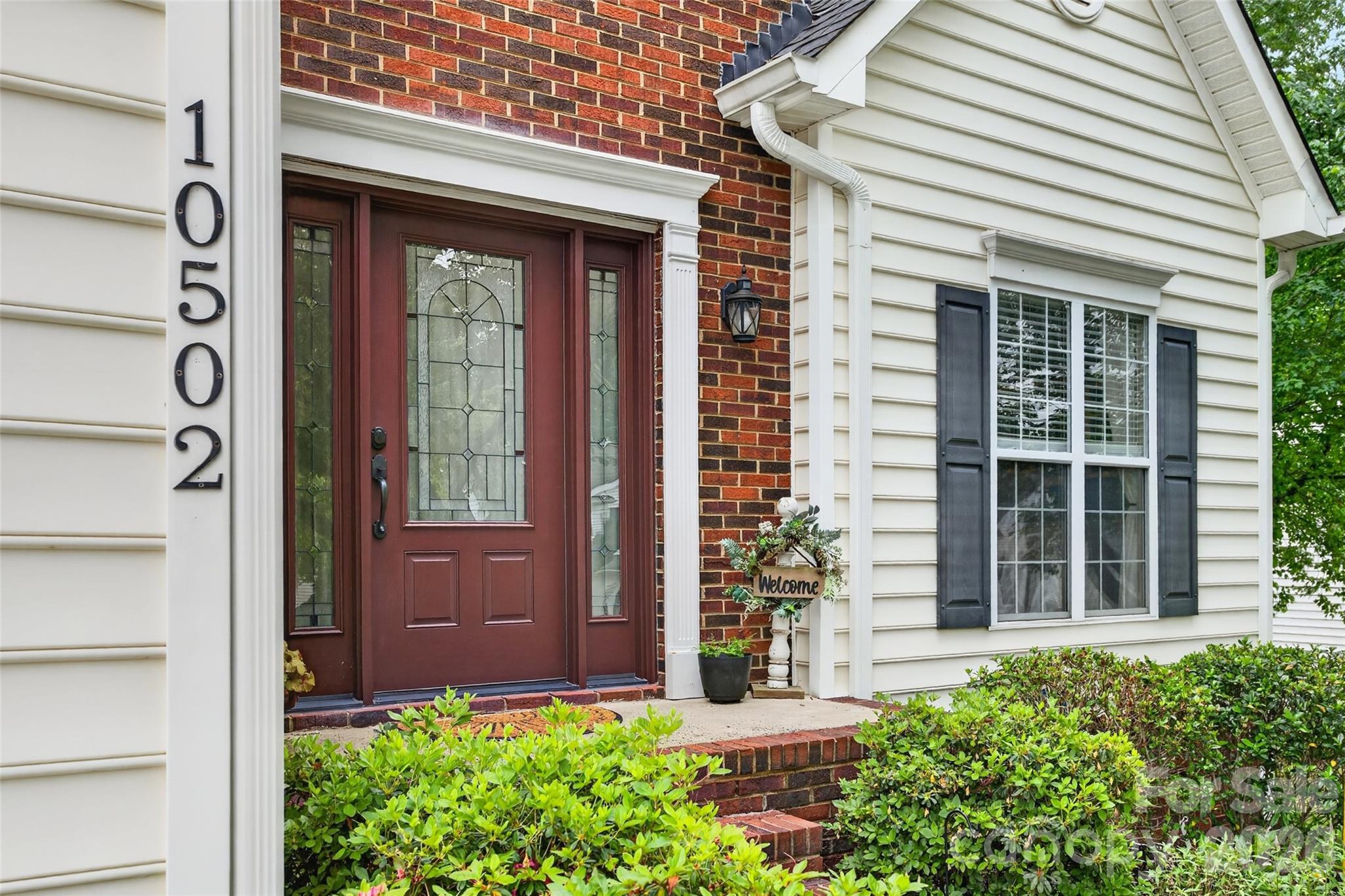 10502 Hellebore Road Charlotte, NC 28213 - Photo 3 of 48 front view of a house with a potted plant and a window