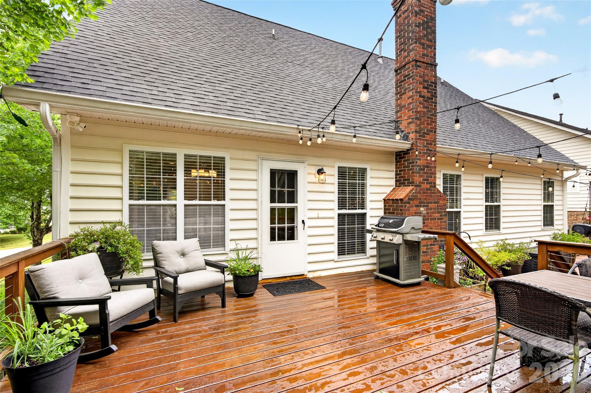 10502 Hellebore Road Charlotte, NC 28213 - Photo 34 of 48 a view of a patio with couches chairs and wooden floor