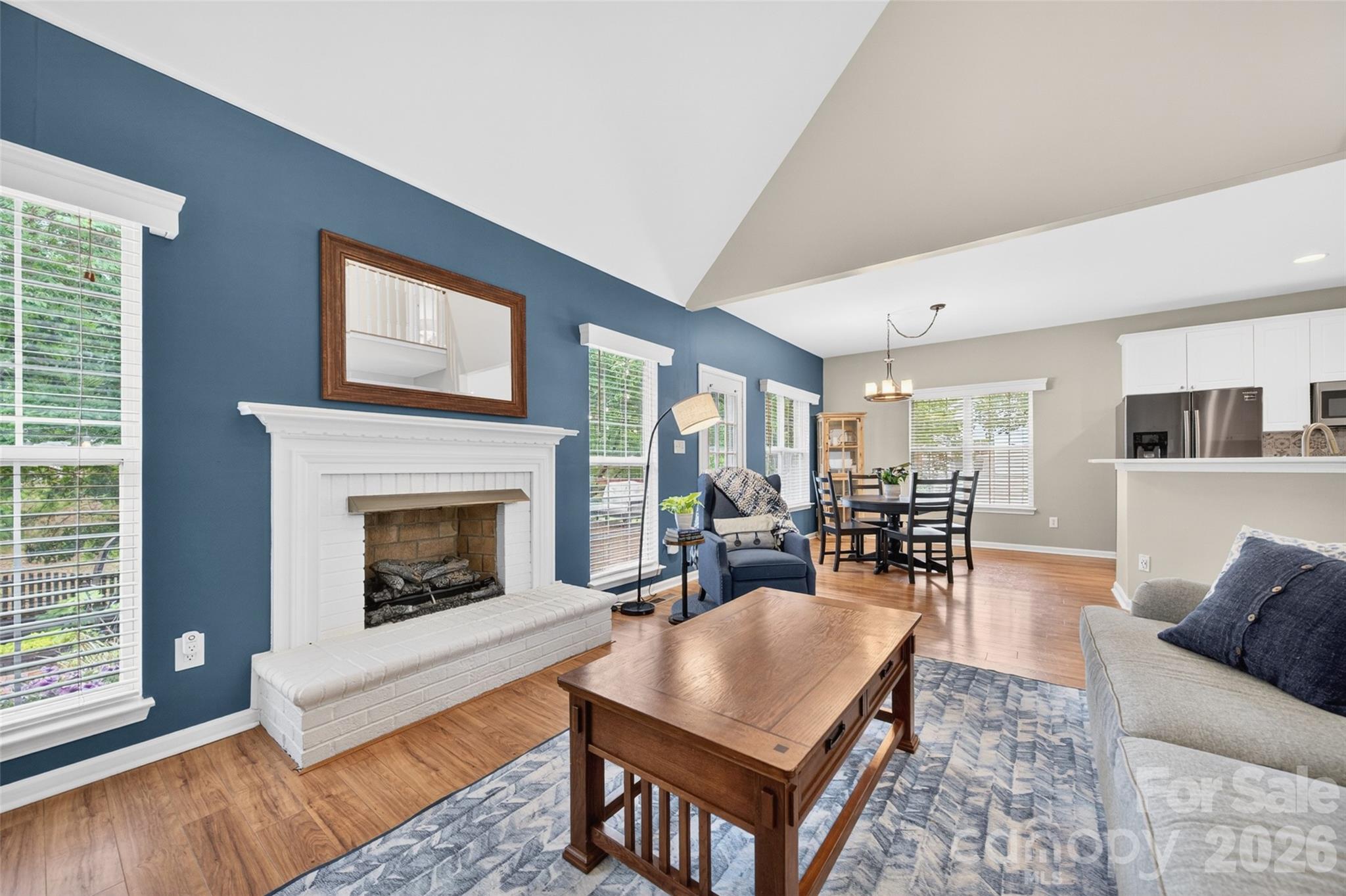 10502 Hellebore Road Charlotte, NC 28213 - Photo 9 of 48 a living room with furniture a fireplace and a table