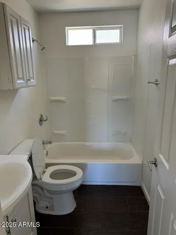 a bathroom with a toilet and a bathtub
