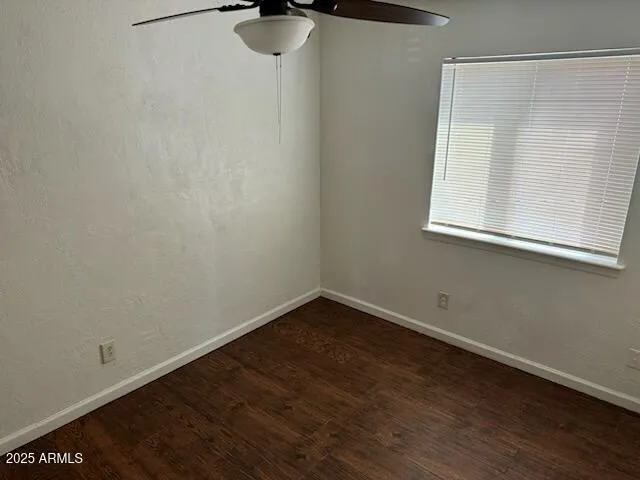 a view of a small space with wooden floor and a window