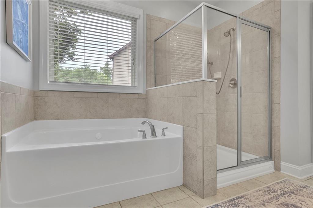 6255 Allison Road Cumming, GA 30040 - Photo 21 of 36 a white bath tub sitting next to a shower
