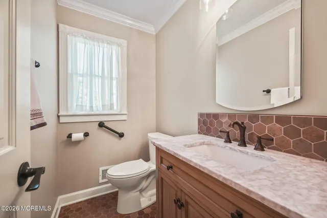 a bathroom with a granite countertop bathtub sink vanity mirror and toilet