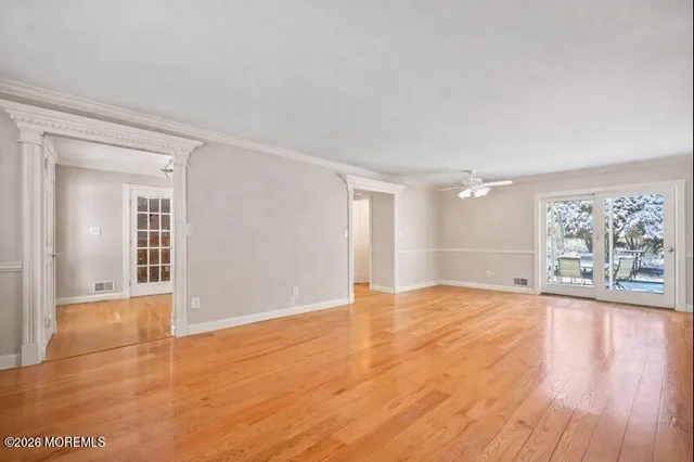 wooden floor in an empty room with a window