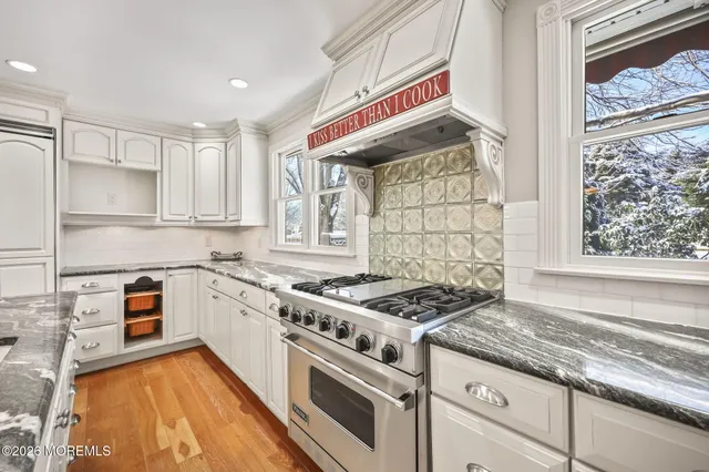 a kitchen with stainless steel appliances granite countertop a stove and a sink