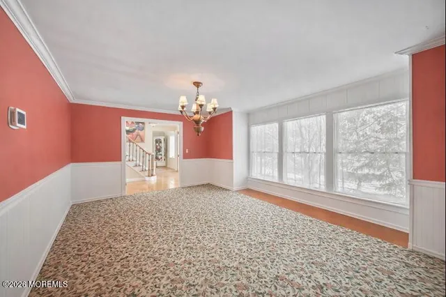 a big room with windows and chandelier