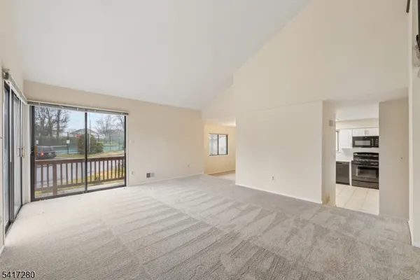 a view of an empty room with glass door