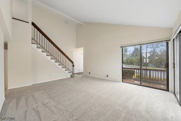 a view of an empty room with stairs