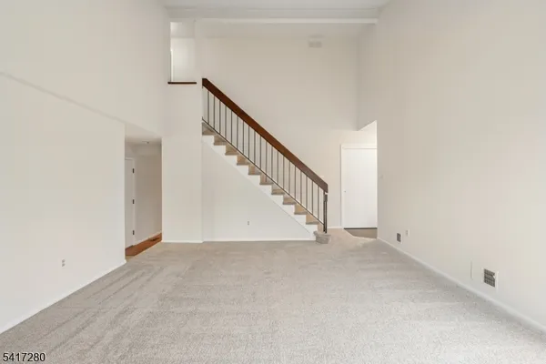 a view of an empty room with stairs