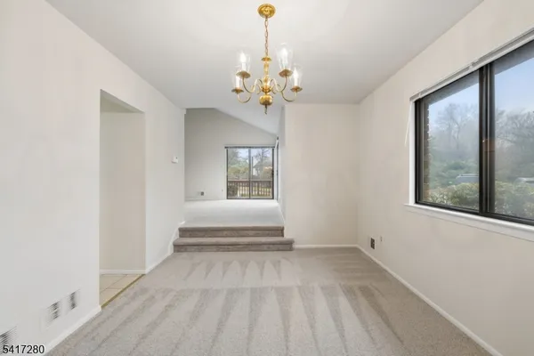 a view of empty room with wooden floor and fireplace