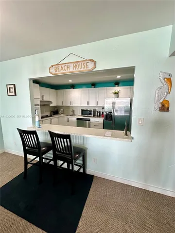 a kitchen with a table and chairs in it