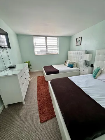 a bedroom with bed and window