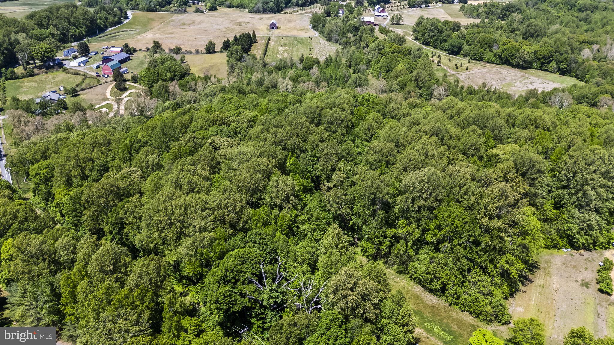 an aerial view of a houses with a yard