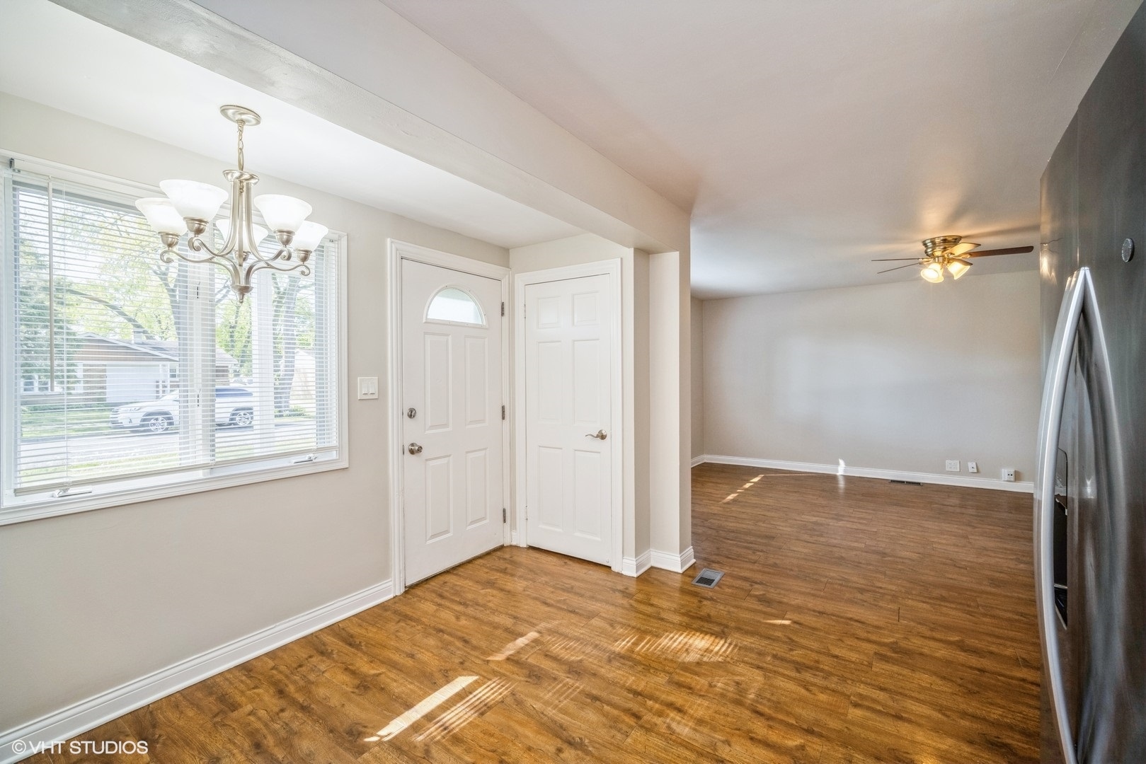 504 Isa Drive Wheeling, IL 60090 - Photo 4 of 13 a view of a livingroom with a chandelier fan and wooden floor