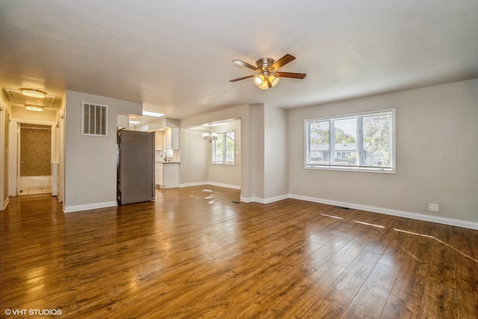 504 Isa Drive Wheeling, IL 60090 - Photo 6 of 13 a view of an empty room with wooden floor and a window